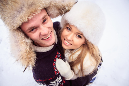 handsome guy with a girl standing arm in arm, close-up, eyes openの写真素材