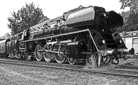 Steam engine in front of special train waiting for departure from the station