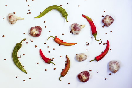 Abstraction of chili peppers and garlic on white background, top viewの写真素材