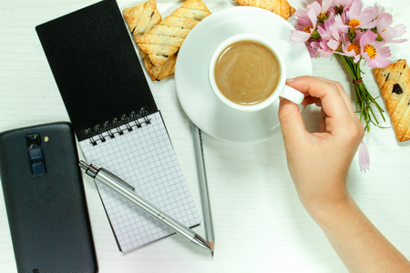 Breakfast of an omelette with sausages and coffee on a white wooden backgroundの写真素材