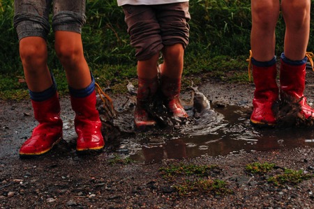 children after the rain with rubber boots