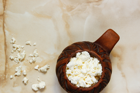 Healthy food. Cottage cheese in a pottery on the table. View from aboveの写真素材