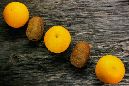 mandarin and kiwi fruit on a wooden table. View from aboveの写真素材