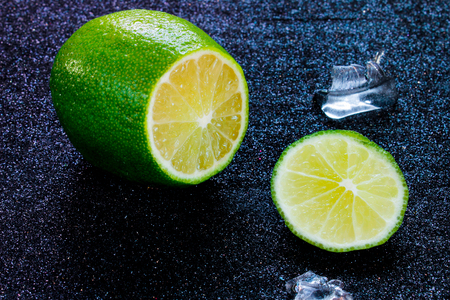 Fresh lime close-up cut in half on a black background.の写真素材