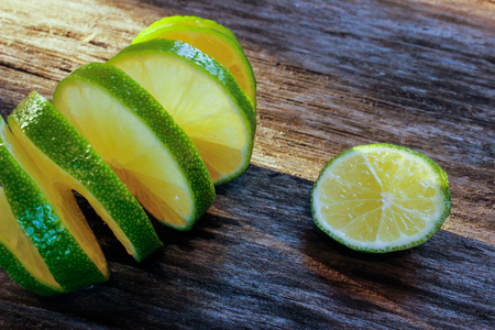 freshly sliced lime on a wooden surface. Close-up, side viewの写真素材