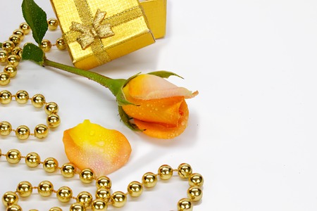 rose with Golden classic shiny open gift box with brown satin bow and beaded garland isolated on white background. Festive postcard. Valentine's Day. New Year's and Christmas. March 8の写真素材
