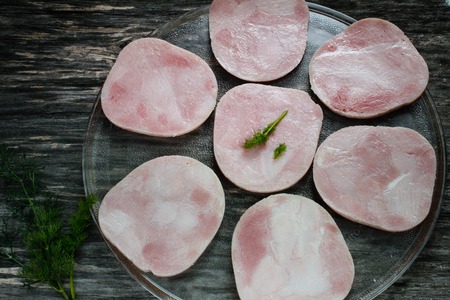 Sliced meat pieces, bacon, cold boiled pork, balyk on a wooden surface. Snack. Meat dish. Close-upの写真素材