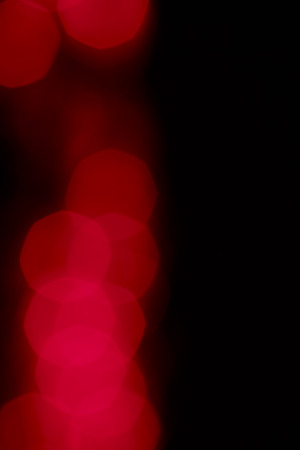 Polygonal red colored light beams in center of solid black background with copy spaceの写真素材