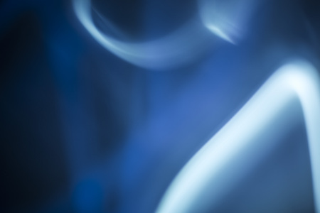 Chaotic background with radial directions of light streaks in blue and white for concept about movementの写真素材