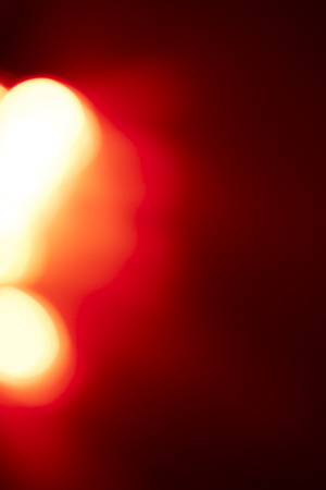 Polygonal red colored light beams in center of solid black background with copy spaceの写真素材