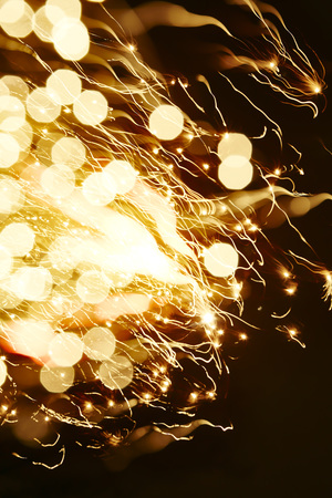 Bright yellow line of sparkling lights in darkness. Use for abstract celebration concept.