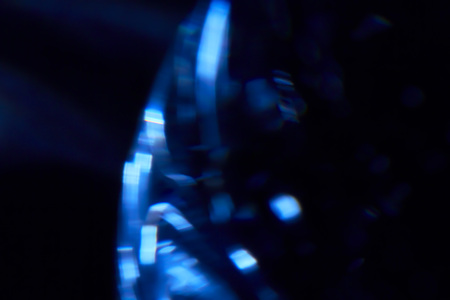 Blue and white streaks of light over black background with copy space for concept about natural gasの写真素材