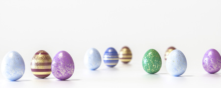 Blue, Red, green, cyan and pink colored Easter eggs balanced on its blunt end on white background...