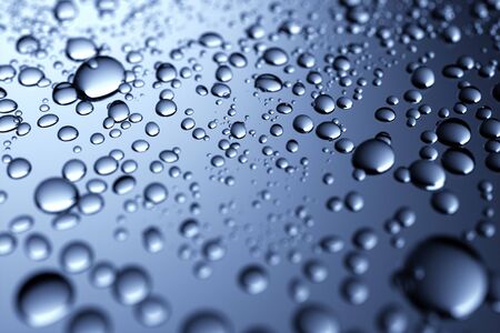 Close up Sparkling water droplets on a translucent black glass background with gradient color for a full frame texture or beauty wallpaperの写真素材