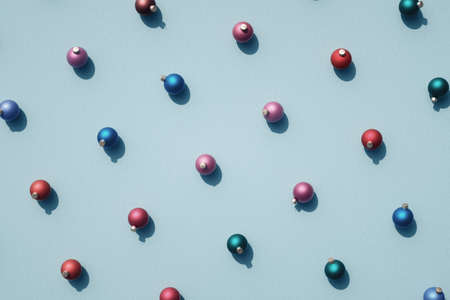 Top view of various color Christmas balls against retro cyan / blue surface. Christmas decoration in rows on textured background.の写真素材