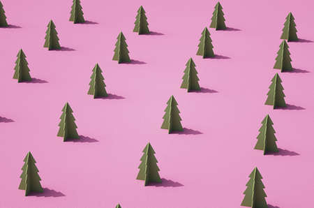 Rows of green 3D conifer tree mockups against retro pink surface. Christmas theme background.