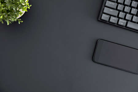Top down view of mobile phone with black blank screen laying on desk. Modern technology, wireless...