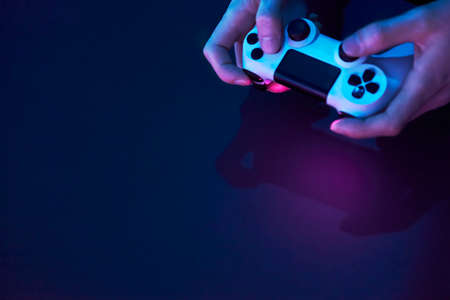 High angle view of male hands holding game controller. Professional computer game playing, esport business and online world concept.の写真素材