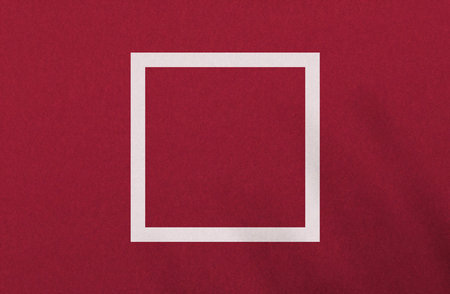 White square on red paper texture. Vivid color fashion background with frame for your objects. Plain graphics element for further work.の写真素材