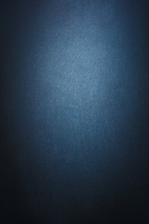 Abstract modern dark textured wall background illuminated by light. Blank template for your text or objects.の写真素材