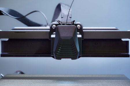 A 3D Printer Head Hovers Above the Build Plate, Prepared to Extrude Filament for Creating Detailed...