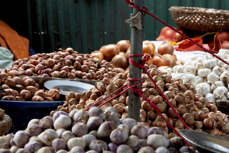 Garlic and shallots in local vendor market with foreground out of focusの写真素材