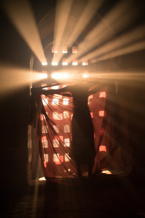 Inside pagoda novice is dressing under the ray of light.Near the Bagan pagodas. Rural landscape and traditional village life in Myanmar(Burma) countryside.の写真素材