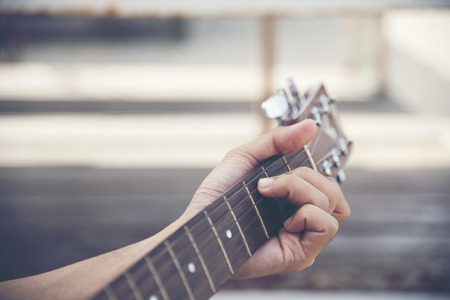 Man hand playing guitar
