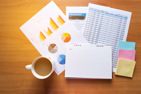 Sales Managers Working Modern Studio.Woman Showing Hand Market Report Charts.Marketing Department Planning New Strategy.Researching Process Wood Table.Horizontal.Blurred Background.Film effect.の写真素材
