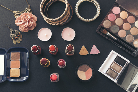 Cosmetics set for beautiful woman with red rose and pearl on pink backgroundの写真素材