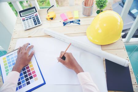 Young architect designer working with new project. Arctitecure Construction Concept.
