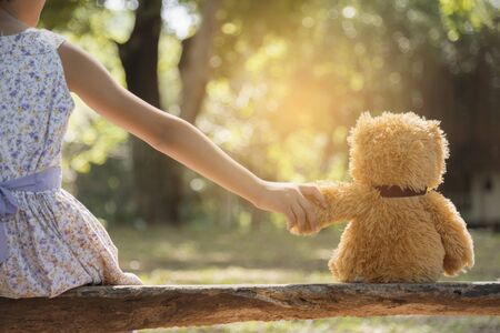 teddy bear is a best friend for all little cute girl. Child autism can be more happy and fun when they're play in family. Feel love and care. Family Friendship Concept.の写真素材