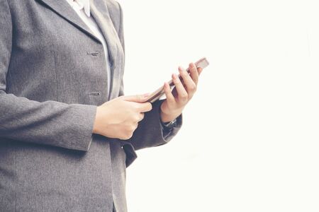 Beautiful young woman wear business formal suit using smart tablet to explore website.の写真素材
