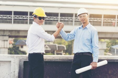 Success Engineer wear yellow helmet for safety consulting together. construction Concept.の写真素材