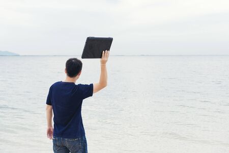 Stressed man losing job throw laptop away. Jobless Concept.の写真素材