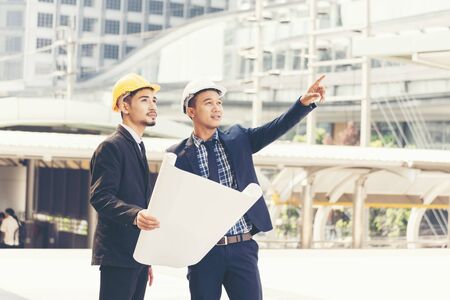 Success Engineer wear white helmet and Foreman yellow helmet for safety. Construction Concept.の写真素材