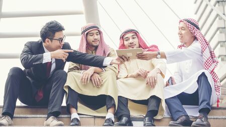 Happy Multi Ethnic communities businessman team collaborator talking about business and new technology in the city view. Diverse Teamwork Business Conceptsの写真素材