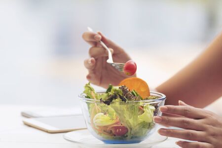 Healthy food fresh vegetable salad. beautiful woman eating healthy ingredient for good health. healthcare concepts.の写真素材