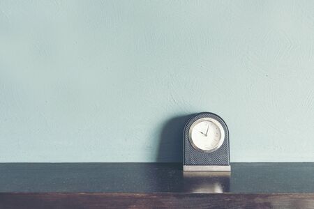 Black Clock at blue wall Time management.