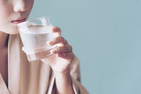 Beautiful woman drinking fresh cold water. Refreshment Skincareの写真素材