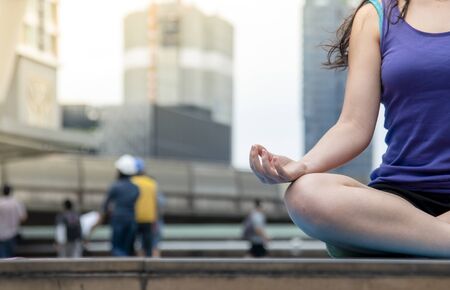 Yoga fitness lifestyle healthy woman relaxation doing a meditation. Yoga meditating outdoor with zen on sitting position. Young exercise concept.の写真素材