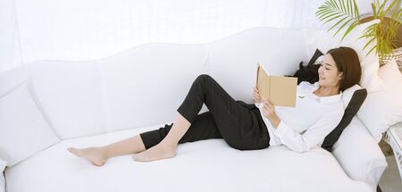 Asian woman using phone shopping online website on smart tablet hand point touch screen digital tablet. Woman holding smartphone checking mail online shopping website read article vlog social mediaの写真素材
