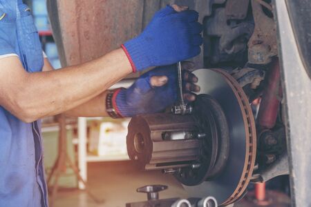 Mechanic Car Service in automotive garage auto car center and vehicles service mechanical engineering. Technician mechanic hands car repairs workshop service center. Services car engine machine.の写真素材