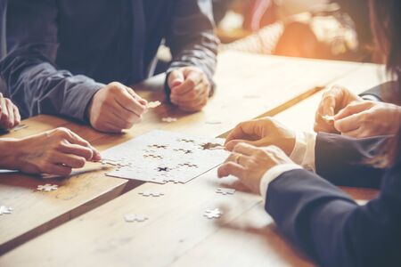 Implement improve puzzel solve connections together with synergy strategy team building organizing connection by trust communication. Hands of stakeholders business trust team holding jigsaw puzzleの写真素材