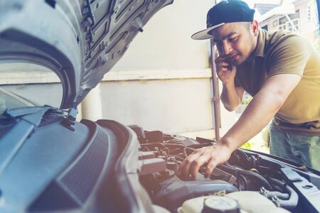 Mechanic Car Service in automobile garage auto car and vehicles service mechanical engineering. Automobile mechanic hands car repairs automotive technician workshop center. Services car engine machineの写真素材