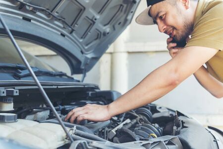 Mechanic Car Service in automobile garage auto car and vehicles service mechanical engineering. Automobile mechanic hands car repairs automotive technician workshop center. Services car engine machineの写真素材