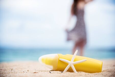 Sunscreen lotion protect woman skin under sunlight burn with uv spf moisturizer on tropical summer outdoor beach. Cosmetic sunblock water resistant tanning wellness factor for woman sunscreen lotionの写真素材