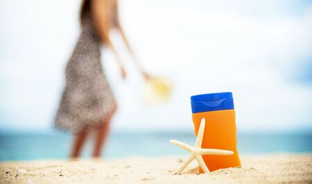 Sunscreen lotion protect woman skin under sunlight burn with uv spf moisturizer on tropical summer outdoor beach. Cosmetic sunblock water resistant tanning wellness factor for woman sunscreen lotionの写真素材