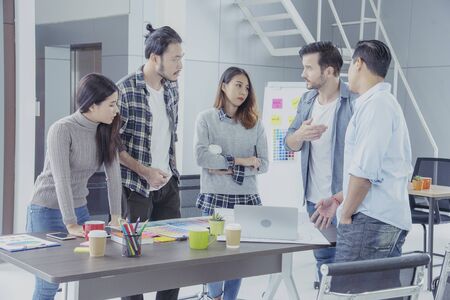 Diversity Creative Design Collaboration Team Meeting Communication with Business Partners Teamwork Working Together in Conference Room. Group of young people Meeting Trust in Businessman and Team.の写真素材