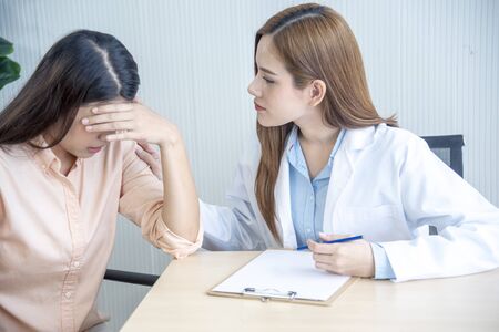 Woman doctor and patient consultation with professional specialist diagnostics at hospital medicare treatment clinic. Doctor writing prescription for medical health care therapy.の写真素材